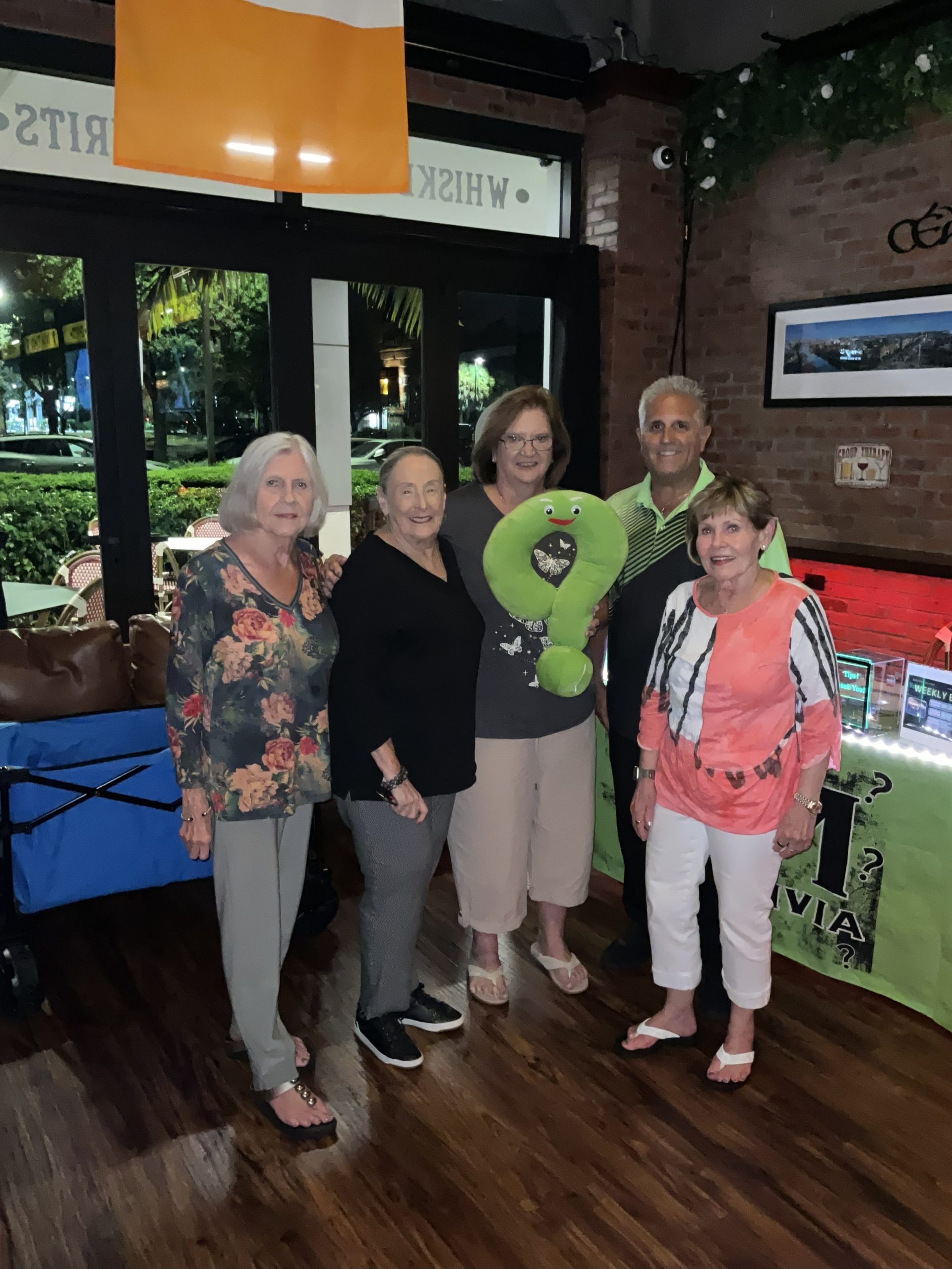 A picture of the Question Maahk Trivia Host Mark Marino with a team who previous won one of his games.